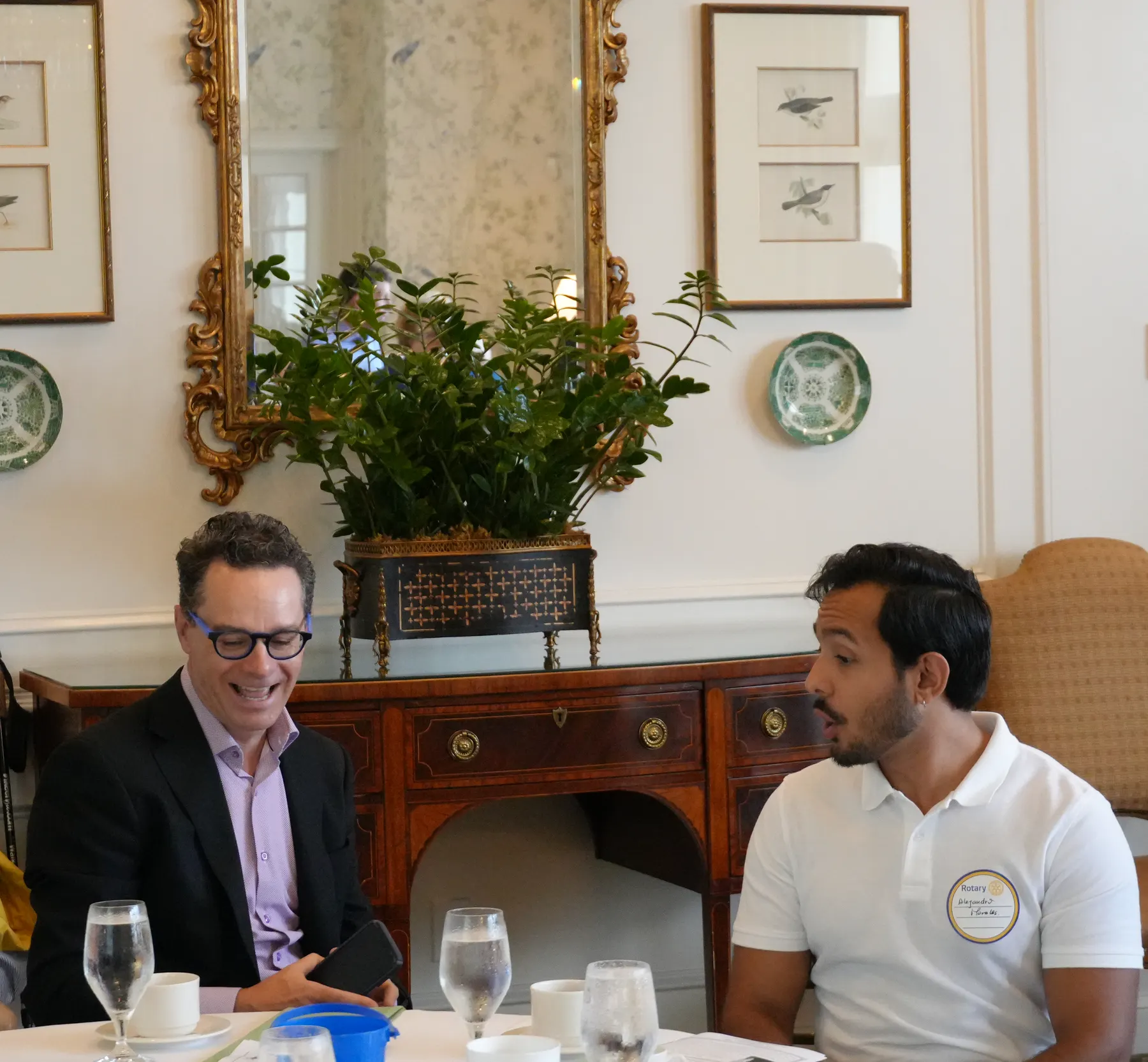 Trevor Chambers talks with Alejandro Morales during a club meeting.