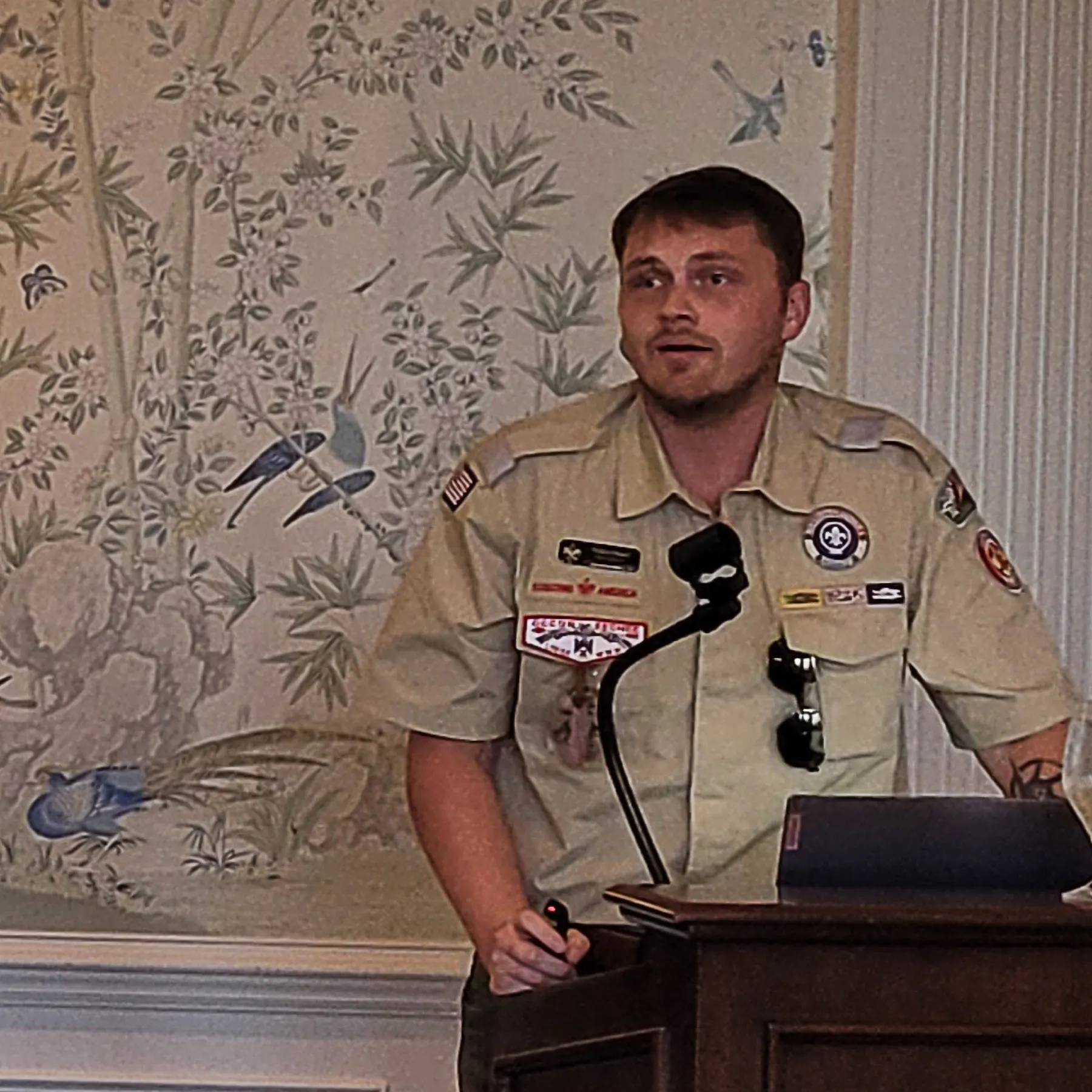 Walker Beard give speech at Rotary meeting.
