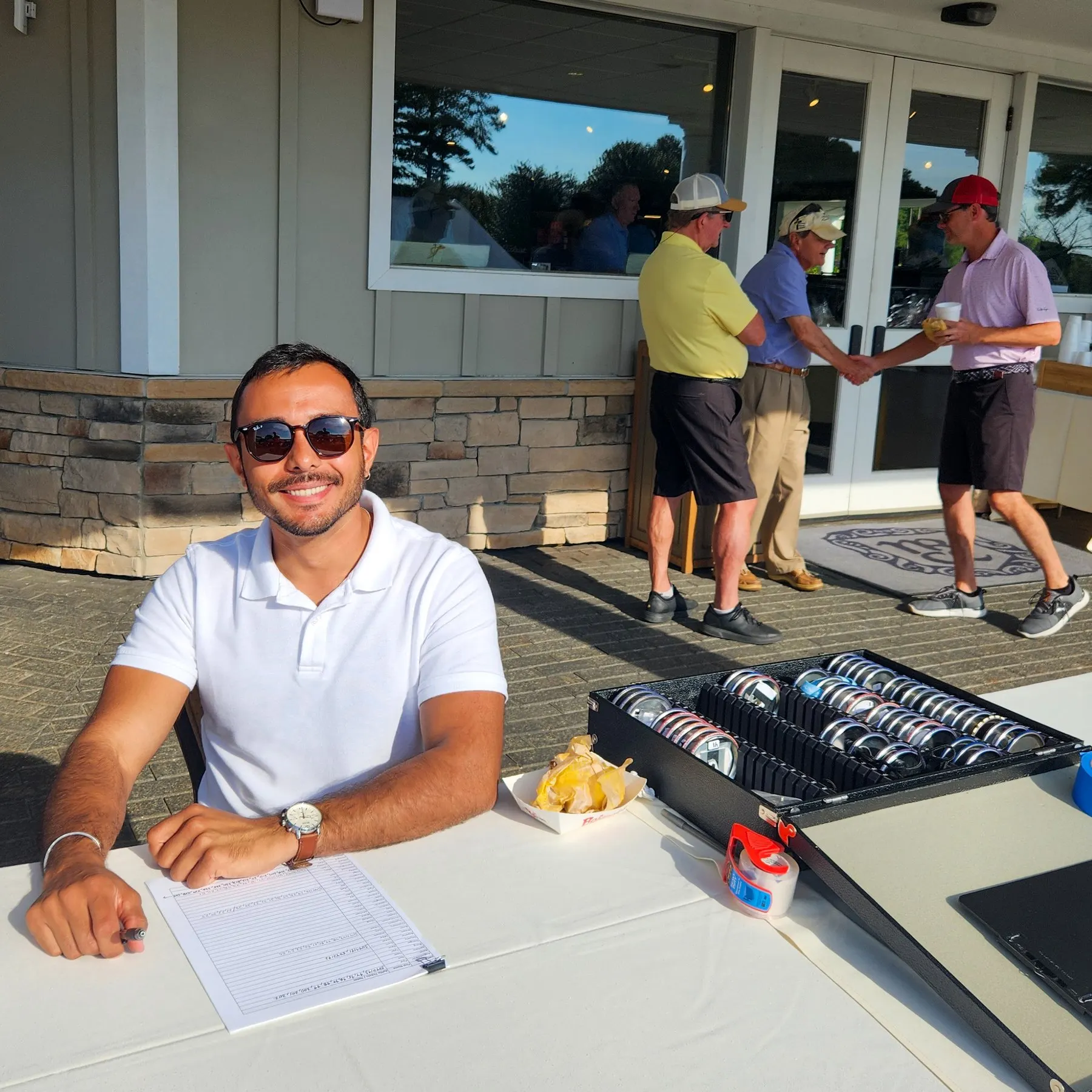A Rotary Club of the Capital City member staffing the registration table at the Golf Classic.